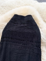 Black openwork maxi skirt with intricate knit patterns and a ribbed waistband.