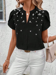 Black embroidered floral keyhole blouse with short puff sleeves.