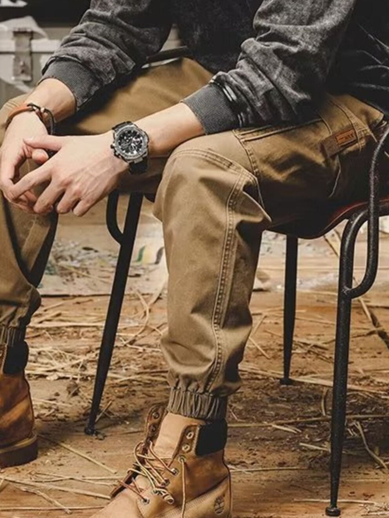 Men's khaki relaxed fit cargo pants with elastic cuffs and a patch detail.