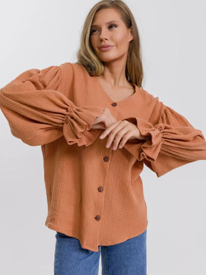 Ochre textured puff sleeve blouse with ruffled cuffs and button front.