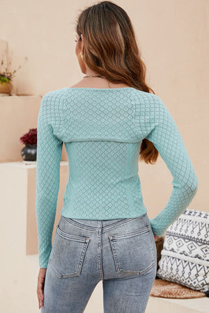 Light green open-knit bolero sleeve top with diamond pattern and scoop neck.