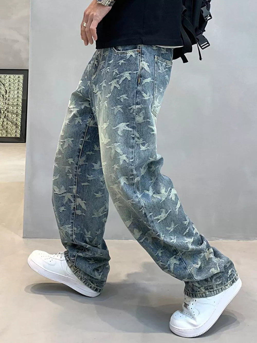 Loose-fit jeans in washed denim with an all-over bird print and vintage wash.