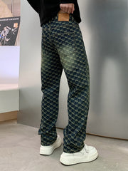 Men's relaxed fit jeans in dark wash denim with all-over woven motif pattern and distressed details.