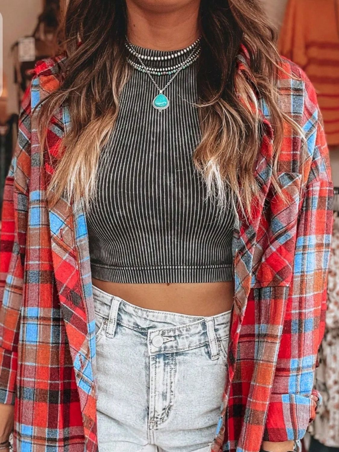 Oversized red plaid shacket with relaxed fit, open front, and long sleeves.