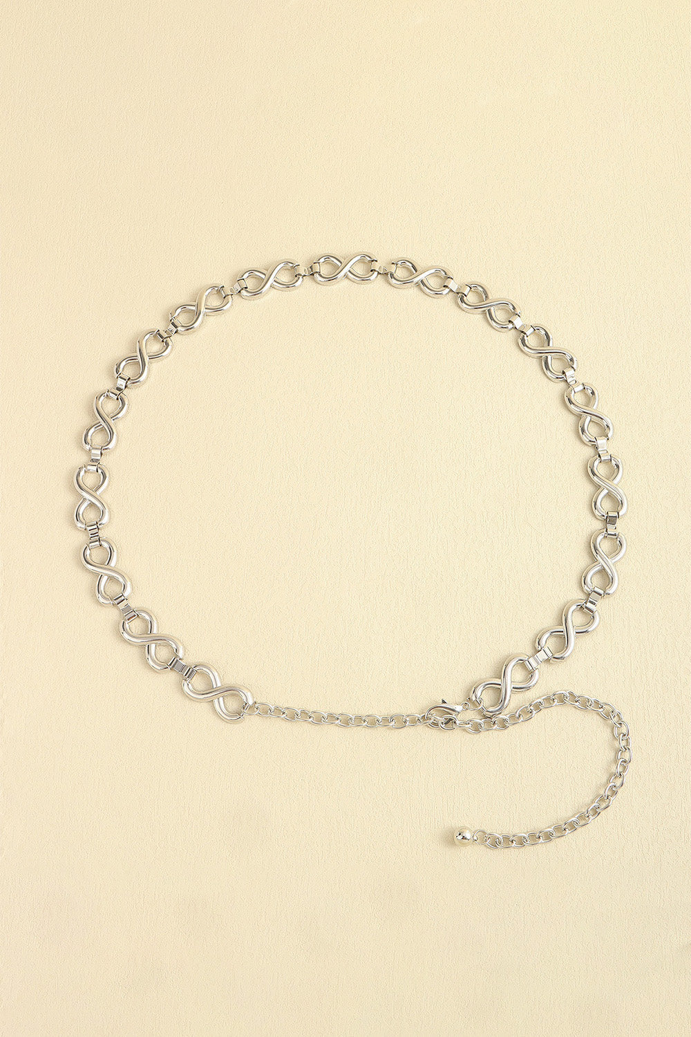 Silver infinity chain belt with adjustable extender and ball end.