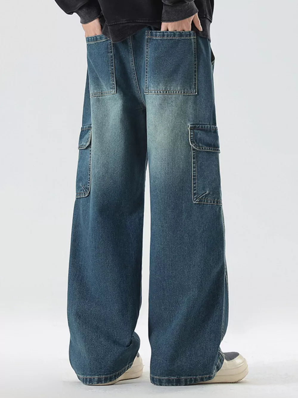 Light blue oversized cargo jeans with drawstring waist and multiple pockets.