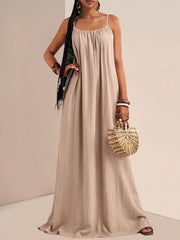 Khaki maxi dress with spaghetti straps and gathered bust, flowing to the floor.
