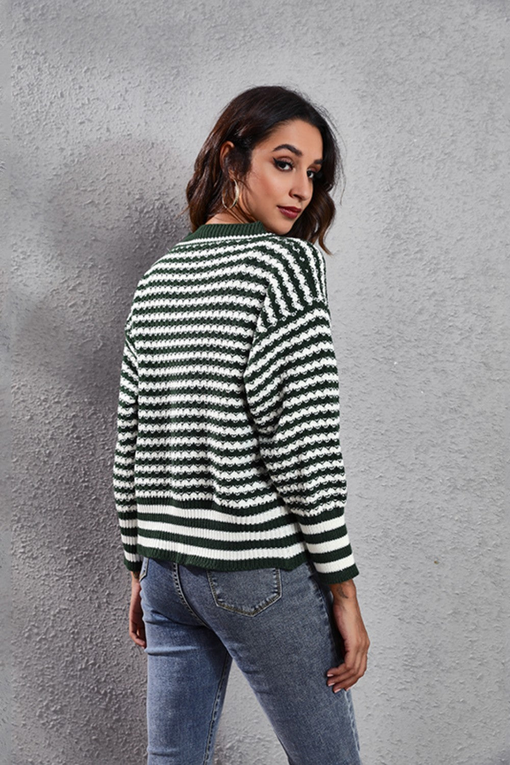 Chevron stripe knit cardigan in Black Forest green and white, with a button front and crew neck.