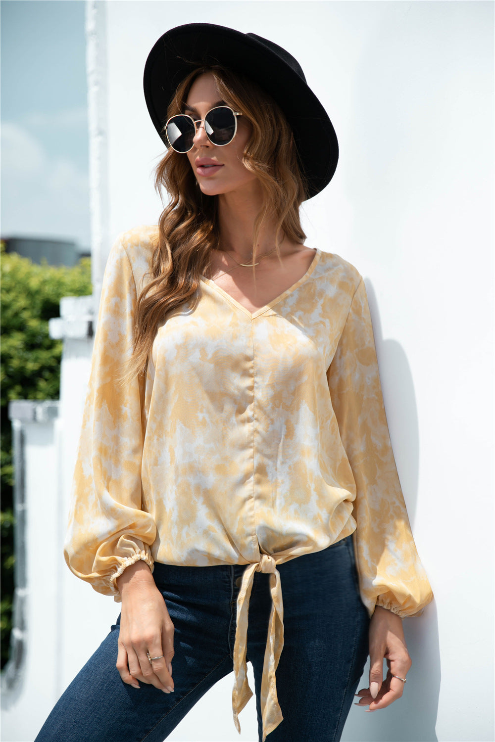 Light yellow swirl print blouson top with balloon sleeves and tie-front detail.