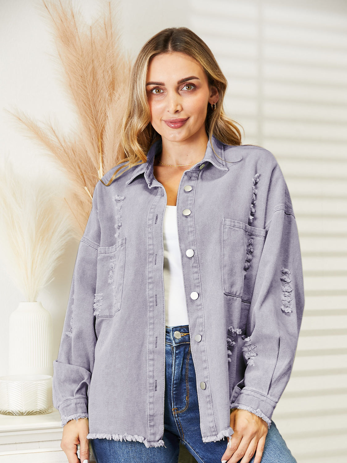 Distressed denim overshirt in lilac with raw hem and button front.