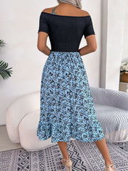 Floral print off-shoulder midi dress in sky blue with black floral pattern and ruffled hem.