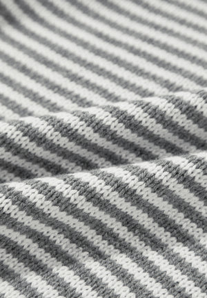 Gray and white geometric stripe knit sweater with a textured weave.
