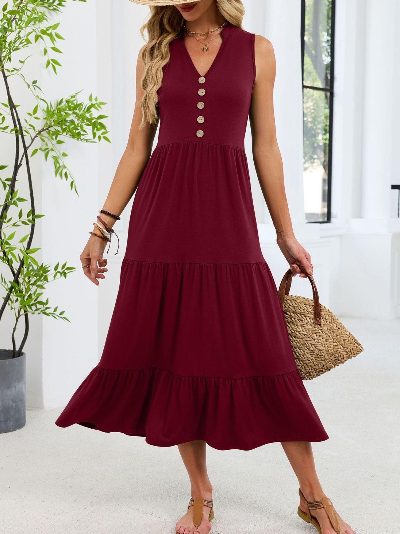 Burgundy tiered midi dress with notched V-neck and decorative buttons.