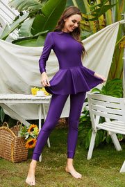 Violet long sleeve swimsuit with flounce hem and matching leggings.