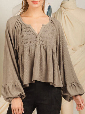 Textured ribbed peplum blouse in tan with smocked yoke and ruffled cuffs