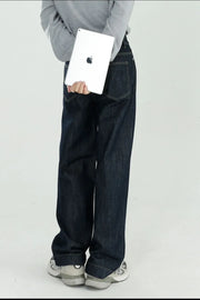 Dark wash wide-leg denim jeans with a relaxed fit, shown from the back.