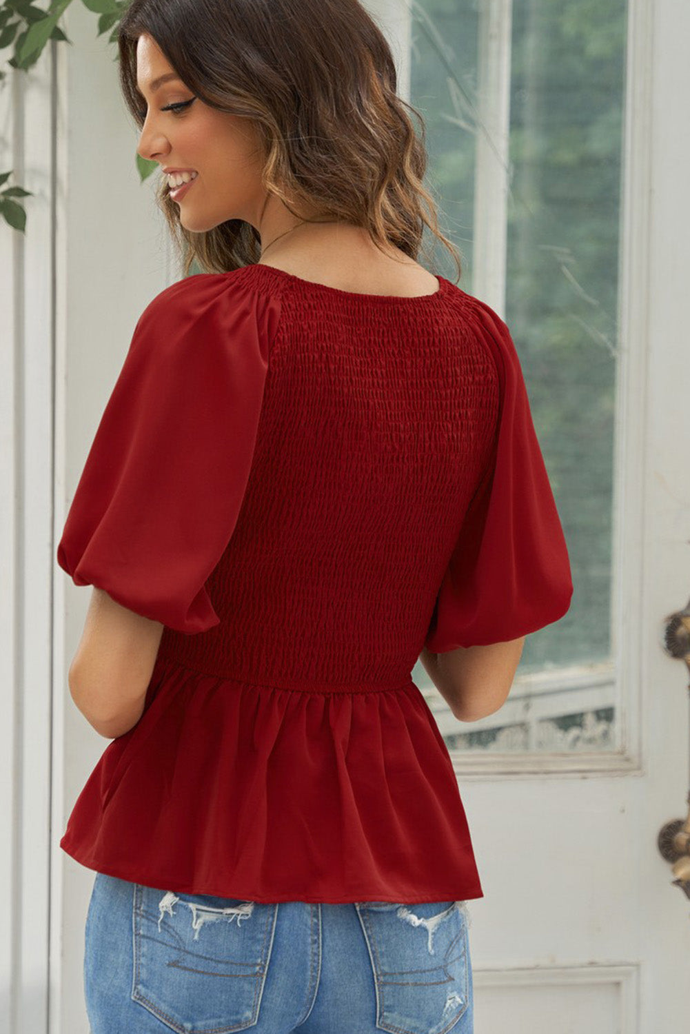Deep Red smocked bodice peplum top with balloon sleeves and ruffled hem.