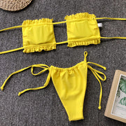 Yellow bandeau bikini set with ruffle trim and tie sides.