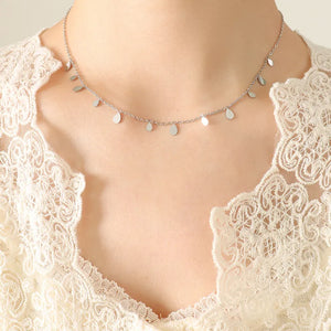 Silver teardrop charm chain necklace with delicate dangling charms.