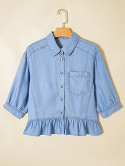 Light blue chambray button-down maternity shirt with ruffled hem and puff sleeves.