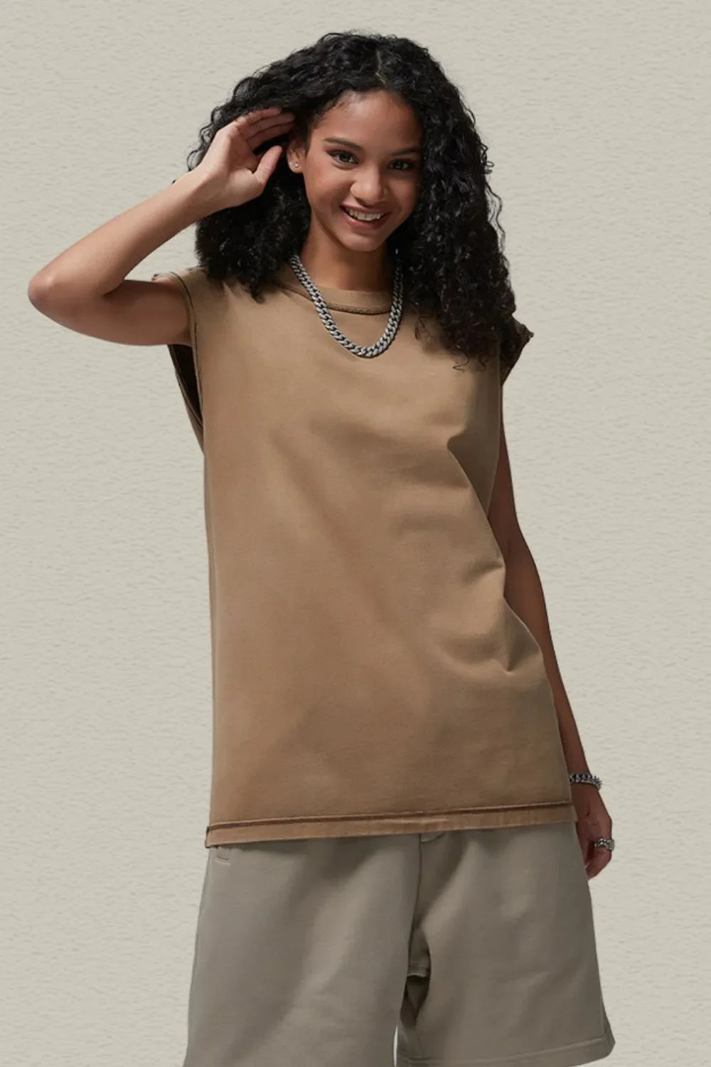 Washed cotton cut-off tank top in khaki with raw hem detail.