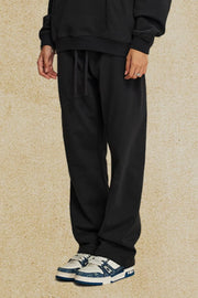 Black relaxed fit joggers with drawstring waist and cuffed ankles.
