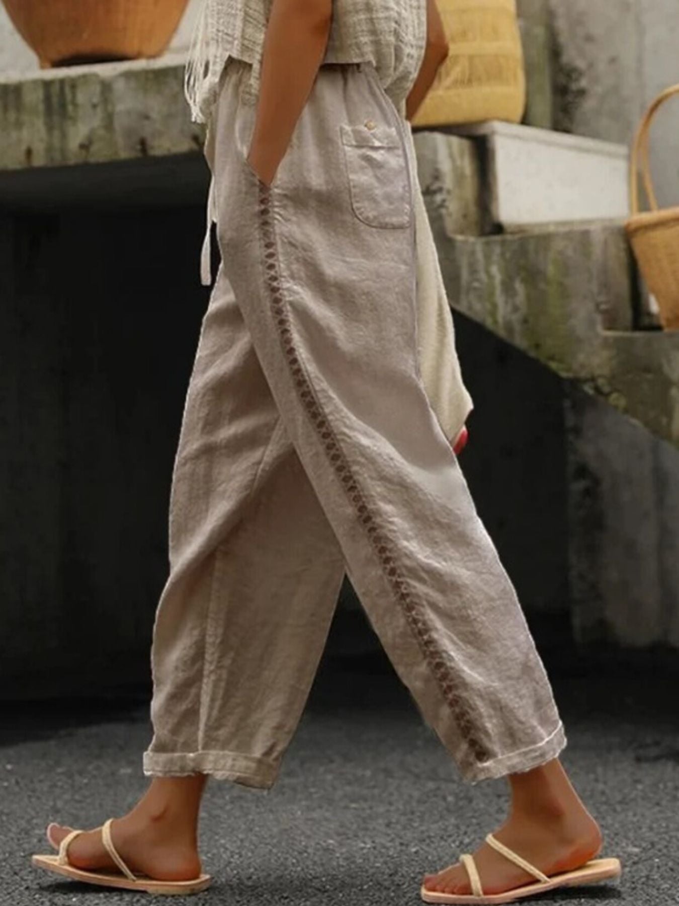Khaki relaxed cropped pants with hollow out trim detail and pockets.
