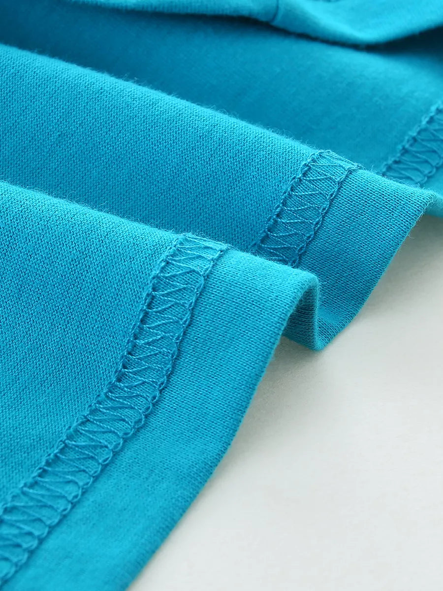 Blue cotton t-shirt detail showing double-stitched hem and seams.