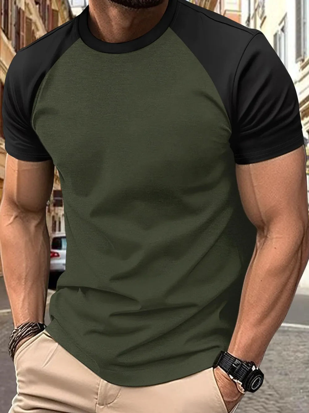 Colorblock raglan tee in olive green with black sleeves and crew neck.