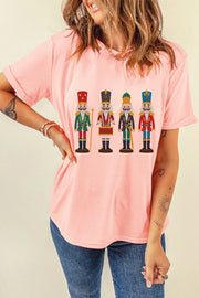 Blush pink t-shirt with a graphic print of four nutcracker soldiers in uniform.