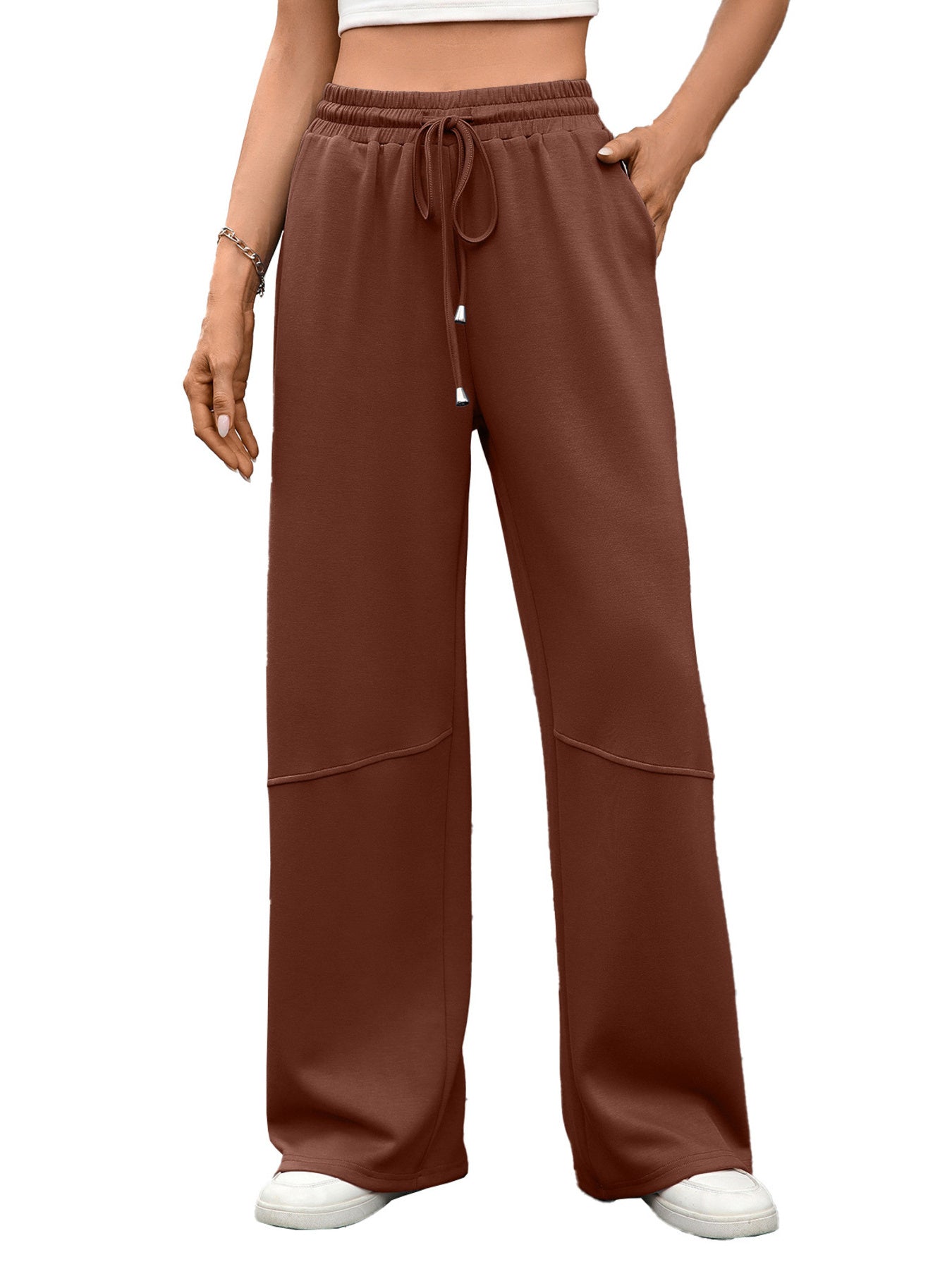 High-waist drawstring wide-leg pants in brown with pockets and paneled detail.
