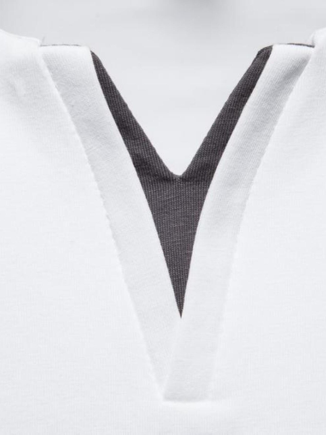White cotton tee with notched dark gray V-neck detail