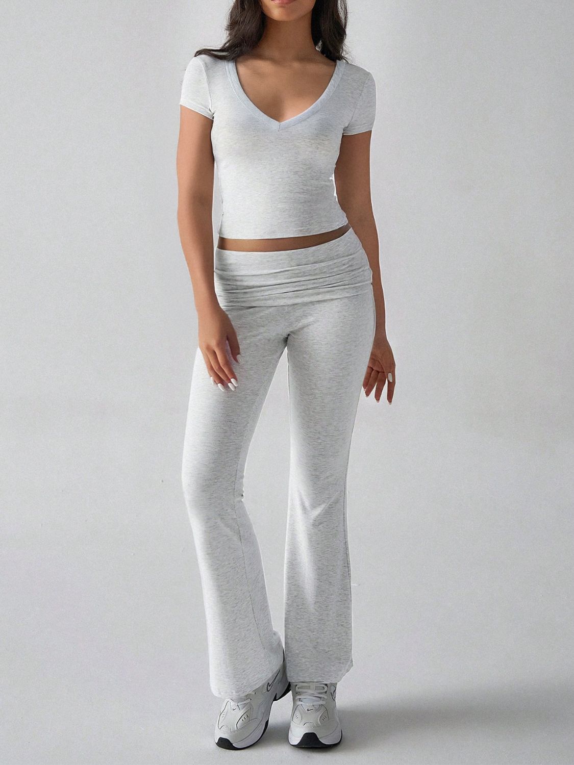 Light gray ribbed flare leg lounge set with v-neck crop top and ruched waistband pants.