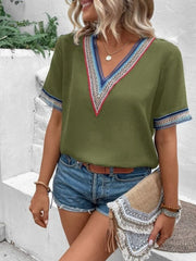 Matcha green v-neck top with embroidered trim on neckline and sleeves