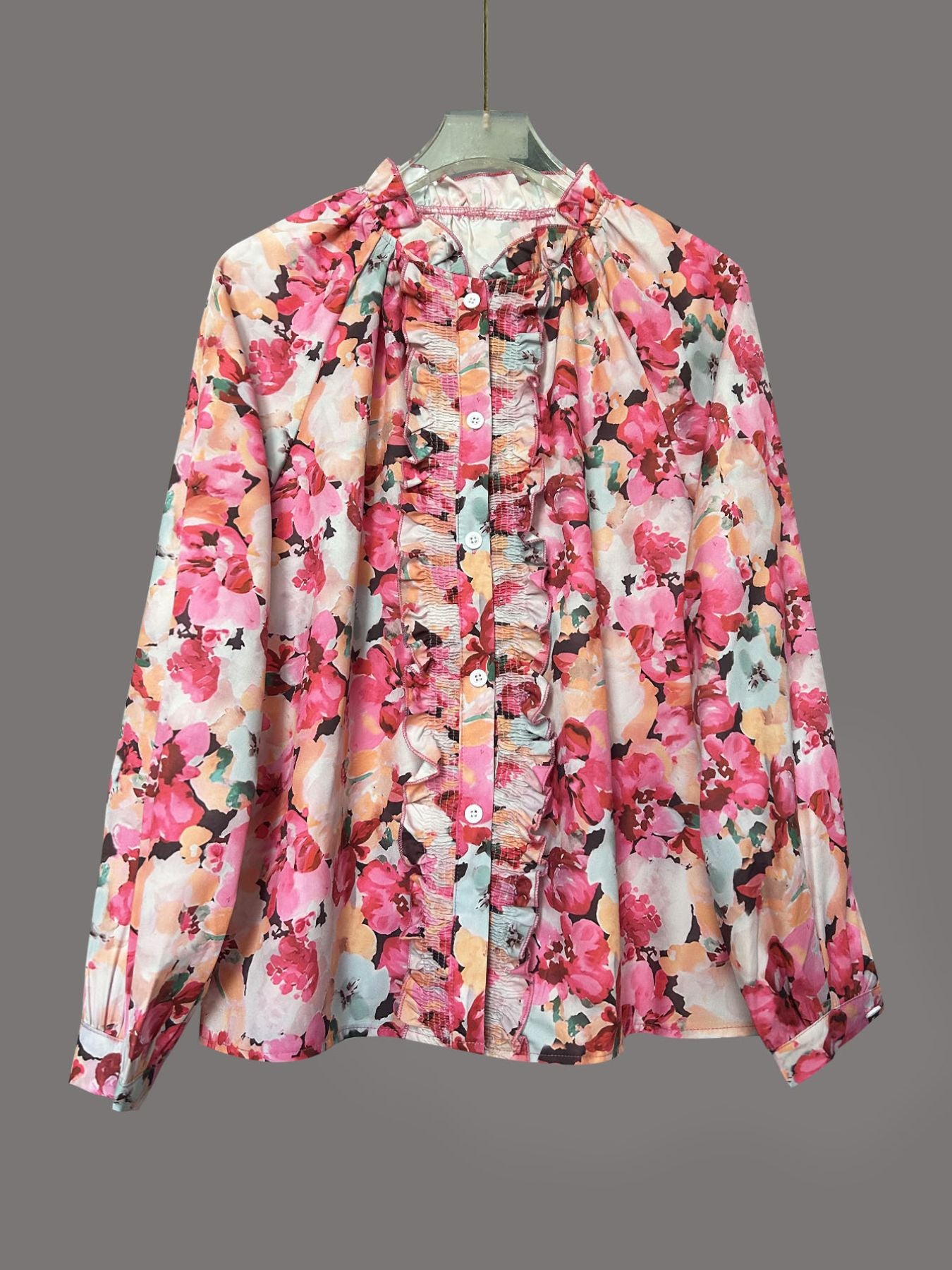 Frill trim button-up shirt with a vibrant floral print and ruffled placket.