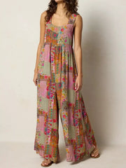 Vibrant patchwork wide-leg romper with a square neckline and wide straps.
