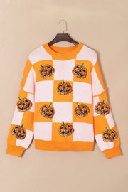 Checkerboard pumpkin appliqué knit sweater in tangerine with crew neck and long sleeves.