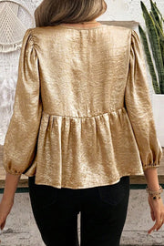 Gold peplum blouse with ruched sleeves and textured fabric.