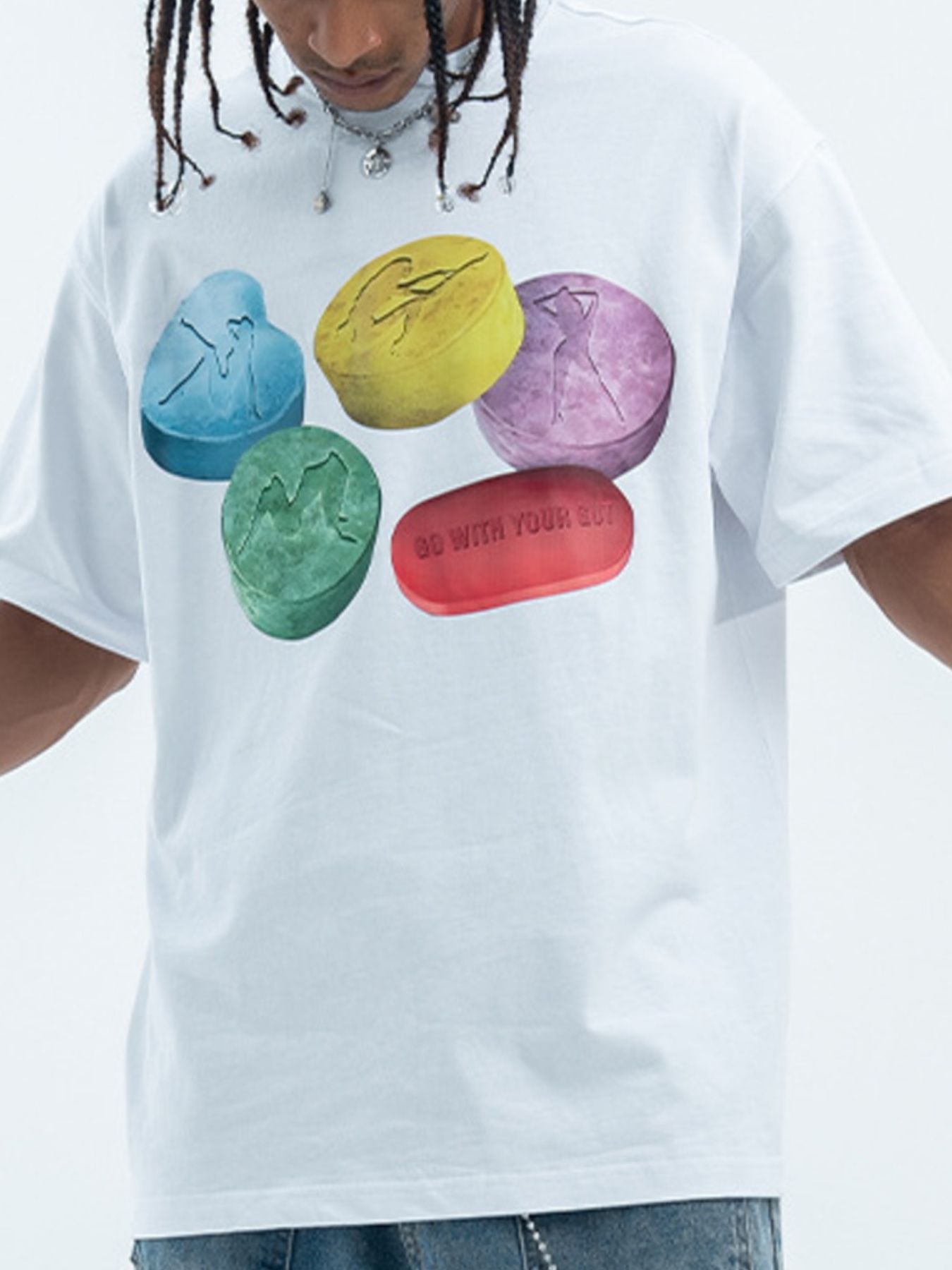 White cotton crew neck t-shirt with graphic print of colorful pills and text.