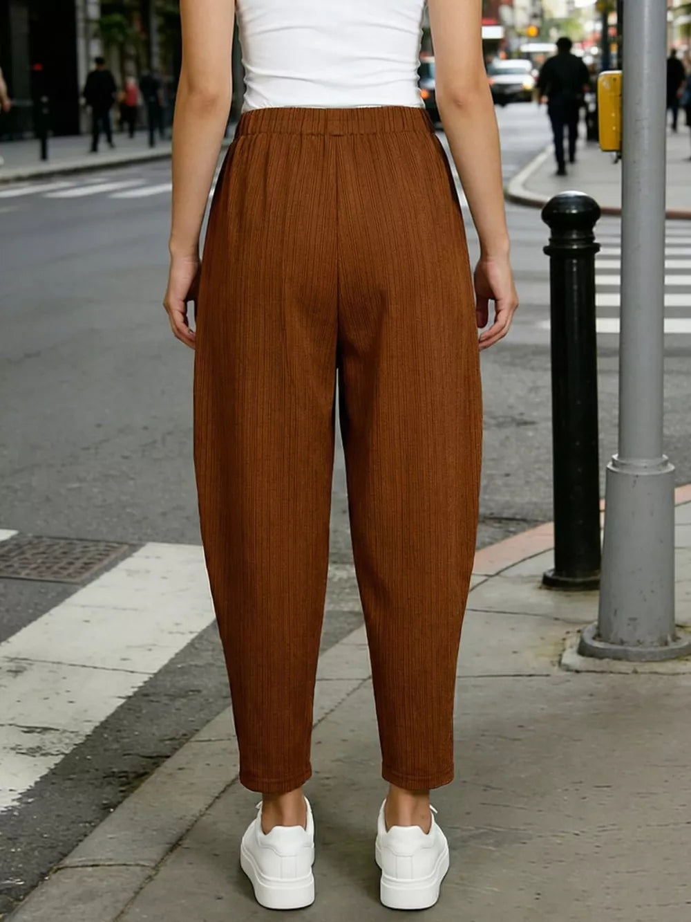 Caramel harem maternity joggers with vertical ribbing and pockets, styled with white sneakers.