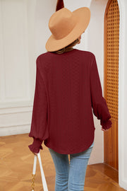 Wine eyelet detail blouse with poet sleeves and ruffled cuffs.