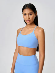 Strappy back active crop top in pastel blue with a square neckline.