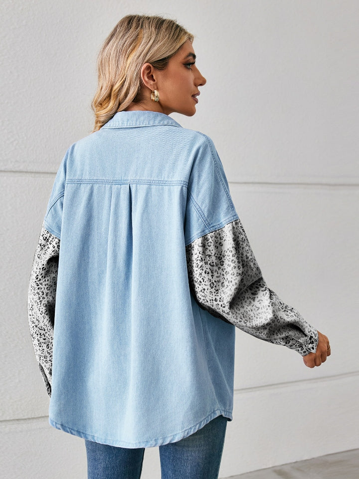Light denim overshirt with leopard print sleeves and button front.