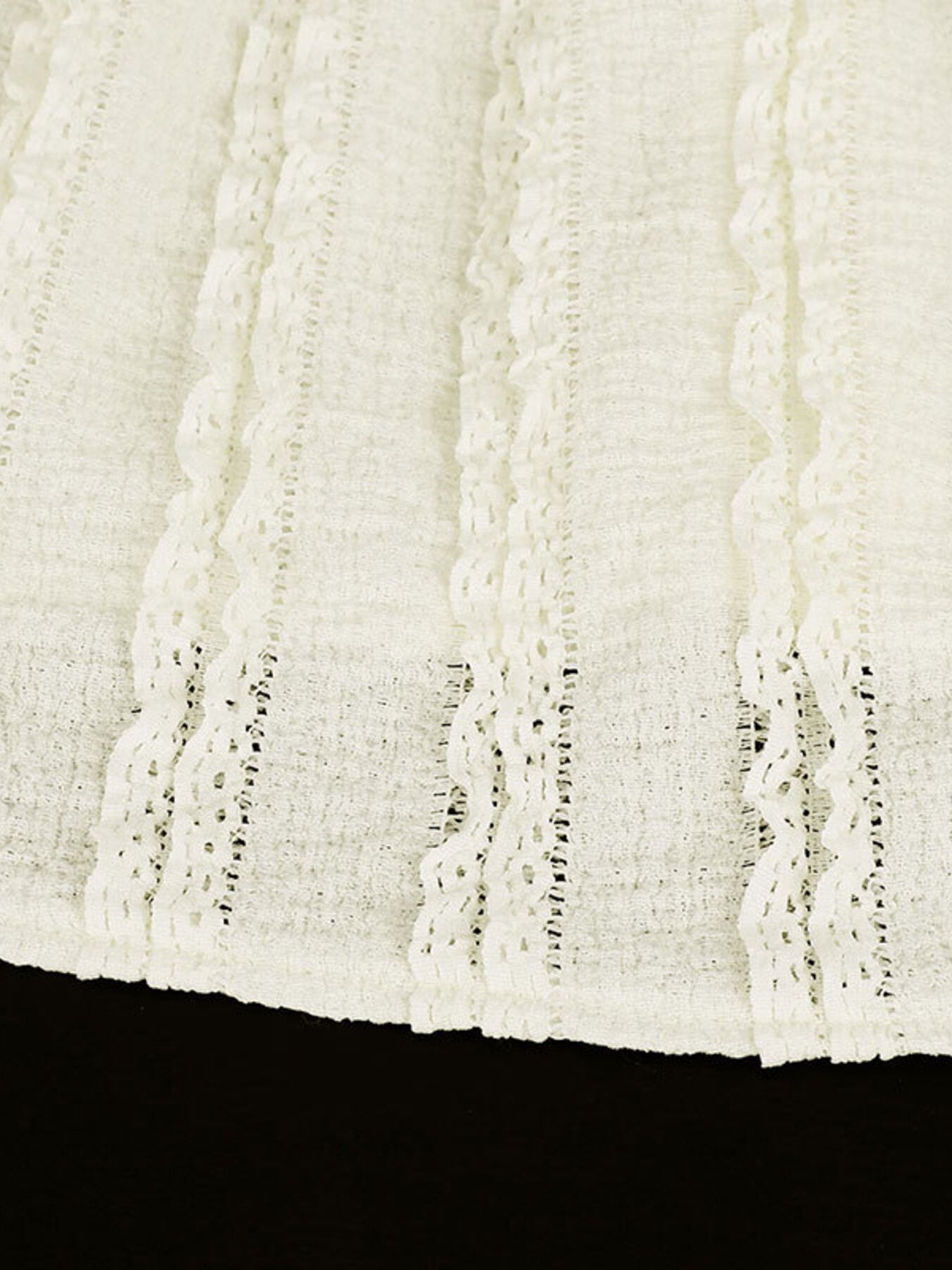 White cami top with vertical textured stripes and lace trim detail