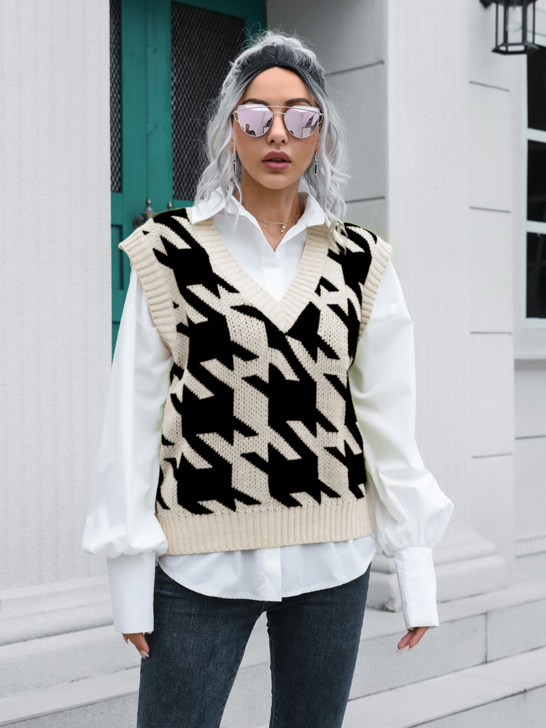 Houndstooth knit v-neck pullover vest in black and beige acrylic, styled over a white shirt.