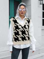 Houndstooth knit v-neck pullover vest in black and beige acrylic, styled over a white shirt.