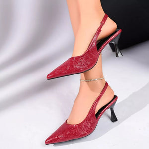 Red embossed slingback kitten heel pumps with pointed toe and ankle strap.