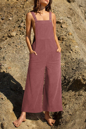 Corduroy overalls in dusty pink with wide legs and front pockets.