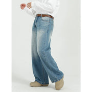 Wide-leg denim jeans in medium wash with pockets and a faded effect.