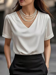 Elegant white satin V-neck shirt with cuffed sleeves and a draped neckline.